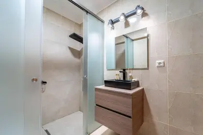 a bathroom with a sink and a mirror at Blue Horizon Apartment by HelloVacations in Albufeira
