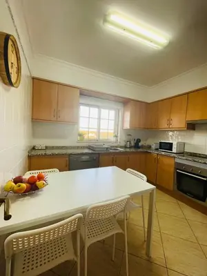a kitchen with a table with a bowl of fruit on it at Invited to Albufeira in Guia