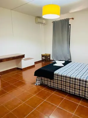 a bedroom with a bed and a piano in a room at Resort Albufeira T1, Praia da Oura in Albufeira