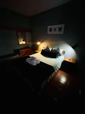 a bedroom with a bed in a dark room at Resort Albufeira T2, Praia da Oura in Albufeira