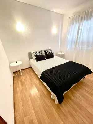 a bedroom with a bed with black and white pillows at Apartament Two bedrooms Praia de Quarteira in Vilamoura