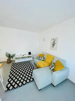 a living room with a couch and a table at Apartament Two bedrooms Praia de Quarteira in Vilamoura