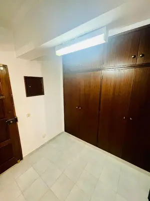 an empty room with wooden cabinets and a large room with at Amazing Studio Flat Albufeira in Albufeira