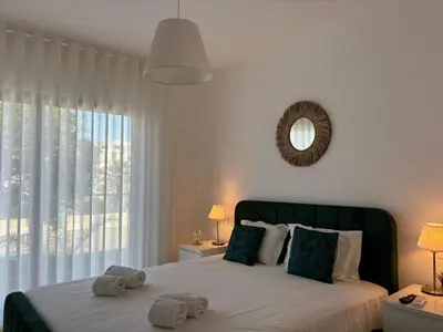 a bedroom with a large bed with towels on it at The Albufeira Concierge - Prime Sunset Design in Albufeira