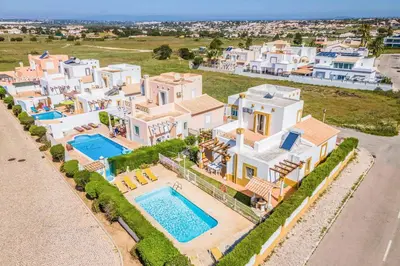 an aerial view of a house with a swimming pool at Villa Ninos in Albufeira