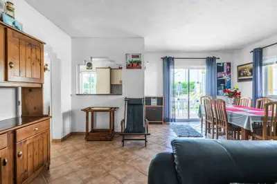 a living room with a kitchen and a dining room at Villa Ninos in Albufeira