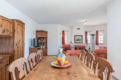 a dining room table with a vase on top of it at Villa Noras in Albufeira