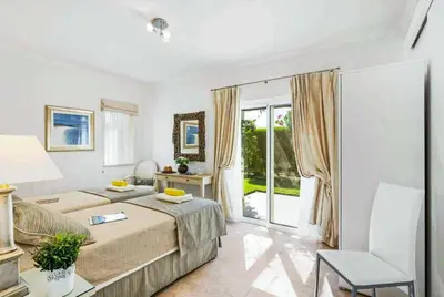 a living room with a couch and a table at Villa Sunset Golf in Vilamoura