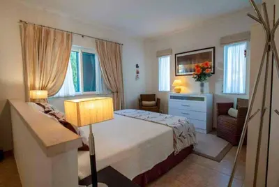 a bedroom with a bed and a bath room at Villa Sunset Golf in Vilamoura