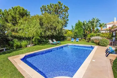 a living room with two couches and a table at Villa Sunset Golf in Vilamoura