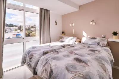 a bedroom with a large bed and a large window at Apartment Bay View Andrea mit Meerblick und Pool in Albufeira