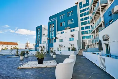 a balcony of a building with white and blue at Apartment Bay View Andrea mit Meerblick und Pool in Albufeira