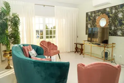 a living room with two chairs and a television at Seaside Serenity Villa in Albufeira