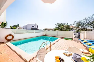 a swimming pool on the roof of a building at Villa Canto in Albufeira