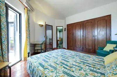 a bedroom with a bed and a large window at Villa Silveira II in Vilamoura