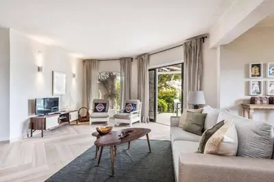a living room with a couch and a table at Villa Silveira II in Vilamoura