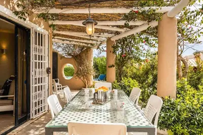 a table and chairs sitting on a patio with anophe at Villa Silveira II in Vilamoura