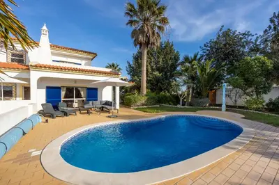 a swimming pool in front of a house at Casa Neel in Boliqueime
