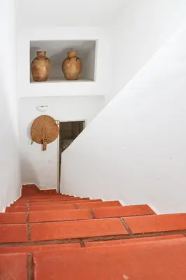 two vases sitting on a shelf above the stairs at Villa Vale de Ursa - 16 - BY BEDZY in Sesmarias