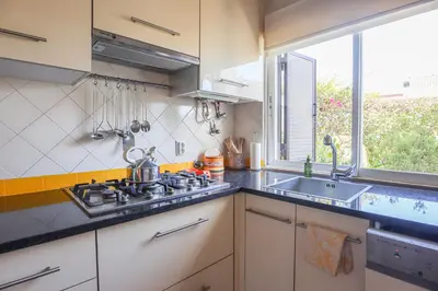 a kitchen with a stove and a sink and a window at Villa Vale de Ursa - 16 - BY BEDZY in Sesmarias