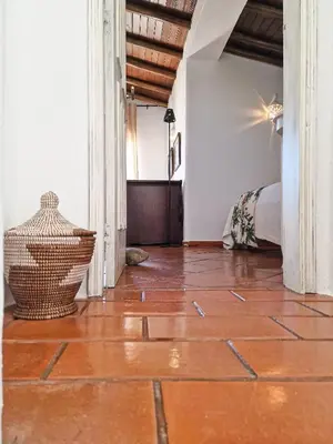 a room with a tile floor and a bed at Villa Vale de Ursa - 16 - BY BEDZY in Sesmarias