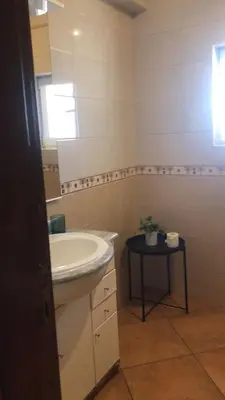 a bathroom with a sink and a mirror at Beautiful Penthouse Two Bed Roof in Albufeira