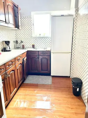 a kitchen with wooden cabinets and a white refrigerator at Beautiful Penthouse Two Bed Roof in Albufeira
