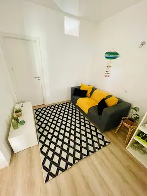 a living room with a couch and a black and white rug at Boutique Two Bedrooms Apartament Praia Da Oura in Albufeira