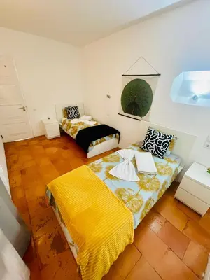 a bedroom with two beds and a yellow blanket at Boutique Two Bedrooms Apartament Praia Da Oura in Albufeira