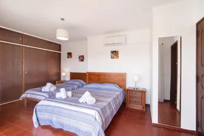 a bedroom with two beds with towels on them at Villa Luísa Galé in Albufeira