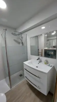 a white bathroom with a sink and a shower at NORA Studio in Quarteira