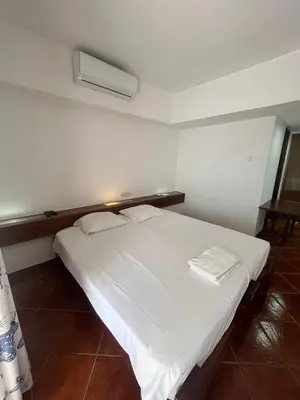 a bedroom with a large white bed with two pillows at TAC - Açoteias Budget Studio in Olhos de Água