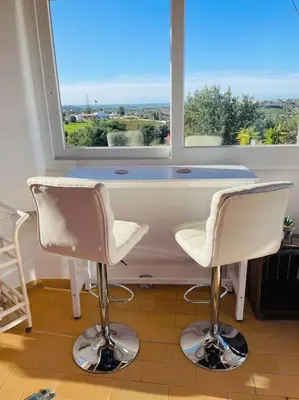 two chairs sitting in front of a window at Self-contained floor of Quinta / Villa in Guia