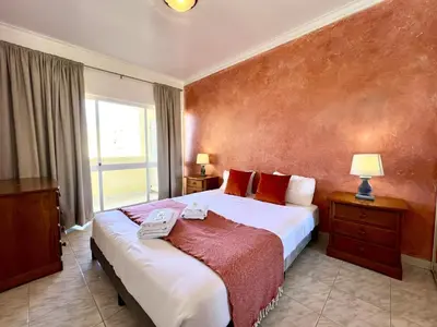 a bedroom with a large bed and a window at Albufeira Concept 2 With Pool by Homing in Galé
