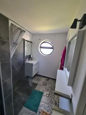 a bathroom with a shower and a sink and a mirror at VILAMOURA APARTMENT NEAR MARINA AND BEACHES in Quarteira