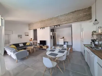 a kitchen and living room with a table and chairs at VILAMOURA APARTMENT NEAR MARINA AND BEACHES in Quarteira