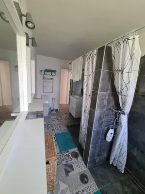 a bathroom with a toilet and a tiled wall at VILAMOURA APARTMENT NEAR MARINA AND BEACHES in Quarteira