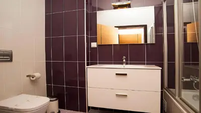 a bathroom with a sink and a toilet and a mirror at Apartamento Oura Mar - By Dalma Portuguesa in Albufeira