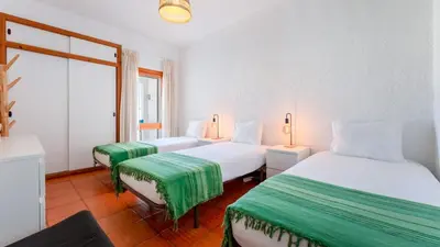 a hotel room with two beds and a window at Comfy 2 BDR Apartment W/ Balcony by LovelyStay in Albufeira