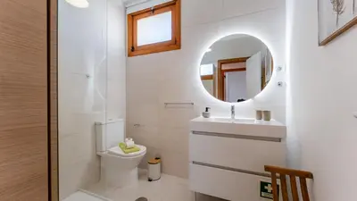 a bathroom with a toilet and a mirror at Comfy 2 BDR Apartment W/ Balcony by LovelyStay in Albufeira