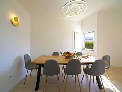 a dining room with a wooden table and chairs at Holiday Home LY - VIP Properties by Interhome in Albufeira