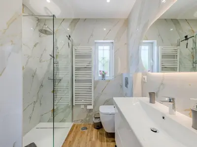 a white bedroom with a large white bed with two towels at Holiday Home Paulo - VIP Properties by Interhome in Galé