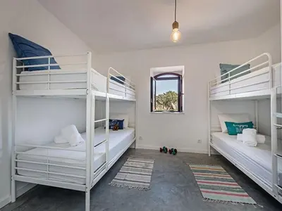 a bedroom with a large bed with towels on it at Villa Recanto Murta V6 VIP Properties by Interhome in Azinhal
