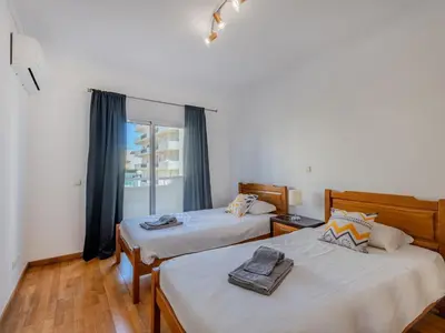 two beds in a room with a window at Holiday Home Camélias VIP Properties by Interhome in Albufeira