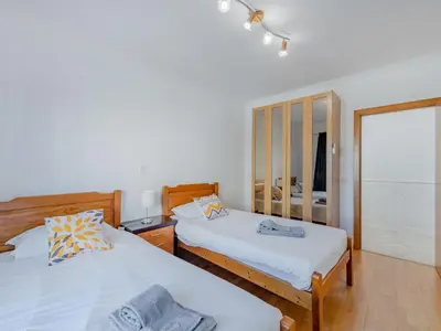 a bedroom with two beds and a mirror at Holiday Home Camélias VIP Properties by Interhome in Albufeira