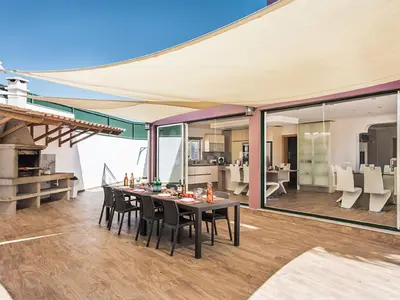 an open dining room with a glass table and white chairs at Villa Quinta Valente VIP Properties by Interhome in Silves