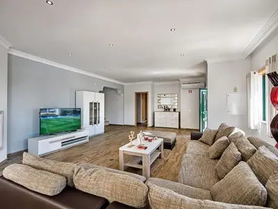 a living room with a large couch and a tv at Villa Quinta Valente VIP Properties by Interhome in Silves