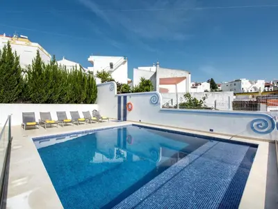a bedroom with a bed with flowers on it at Holiday Home Cristal VIP Properties by Interhome in Albufeira