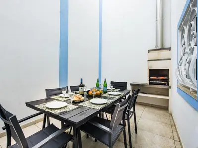 a dining room with a table and chairs and an oven at Holiday Home Cristal VIP Properties by Interhome in Albufeira