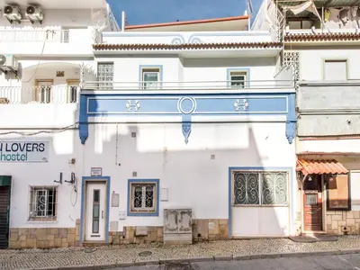 a white building with a blue sign on it at Holiday Home Cristal VIP Properties by Interhome in Albufeira